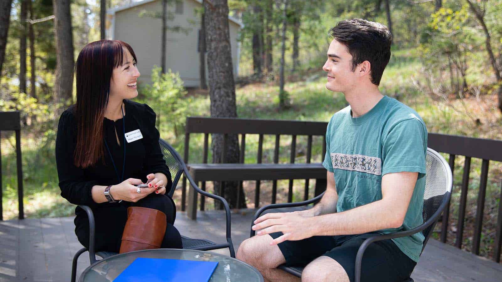 Sandstone Care therapist meeting with teen outdoors for mental health and addiction recovery support