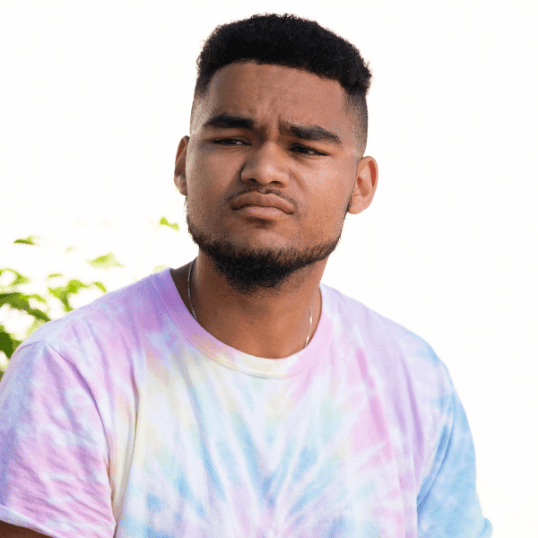 arafed man with a tie dye shirt and a cell phone