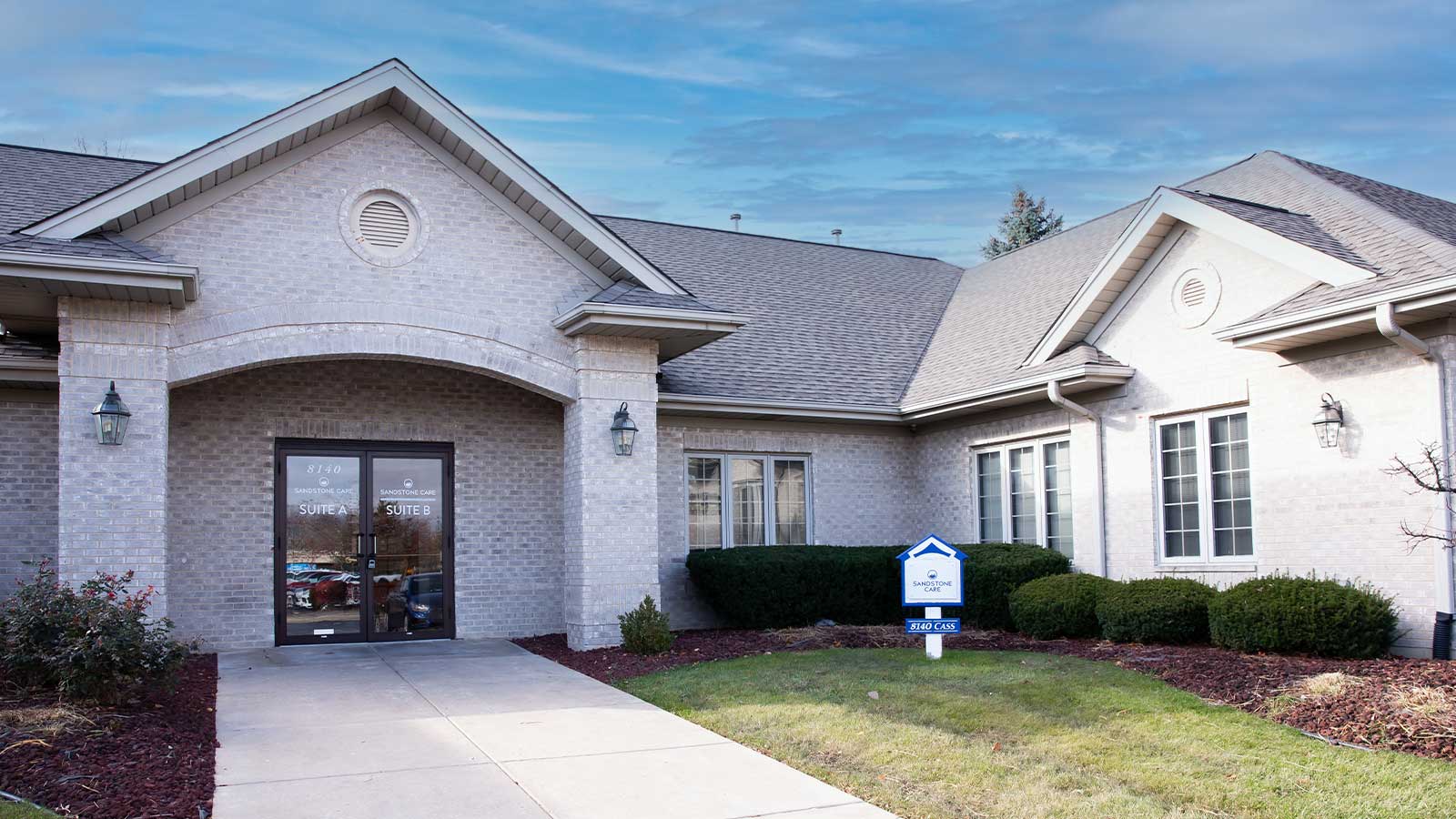 there is a house with a blue sign in front of it