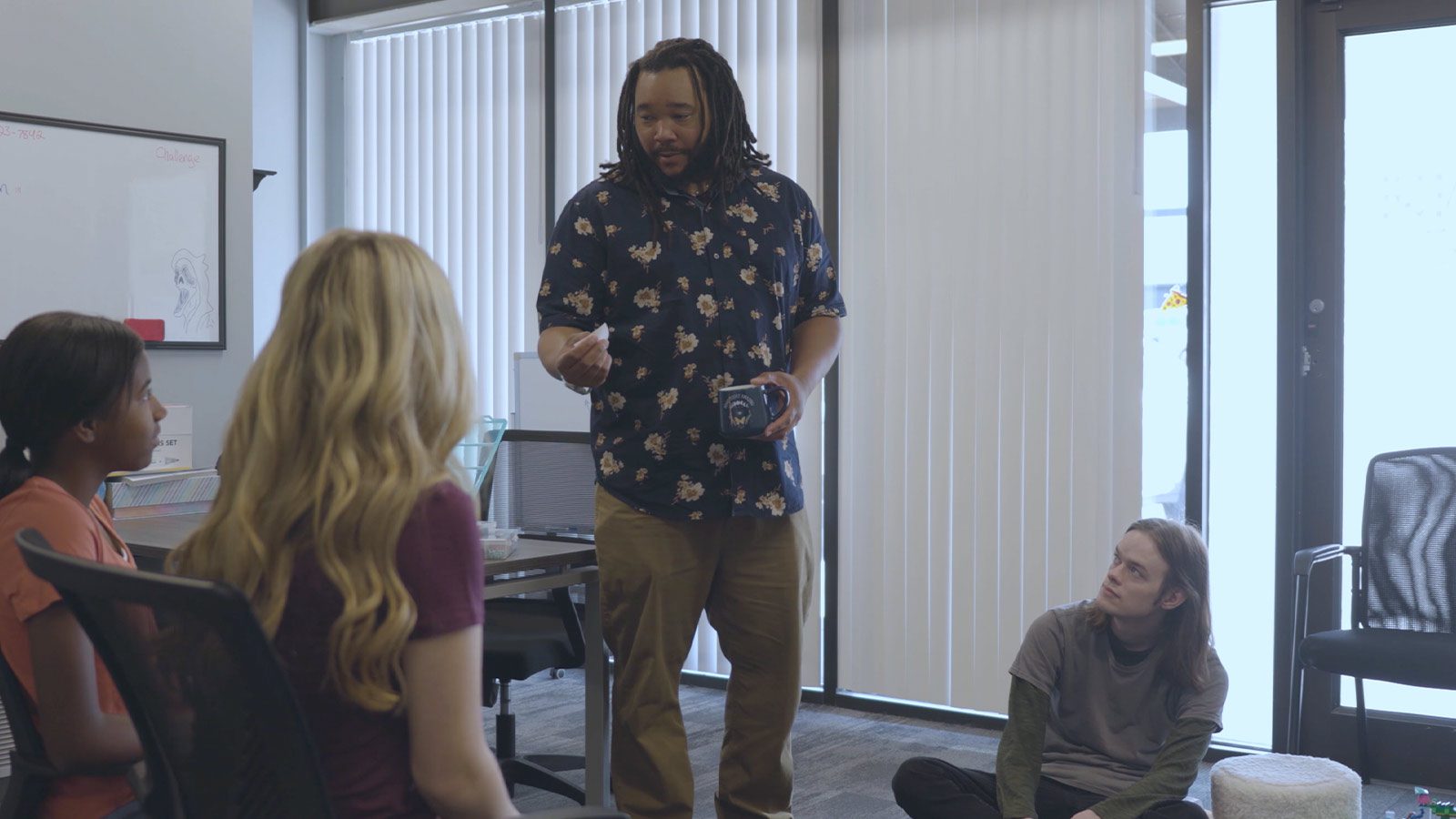 Male therapist speaking to a group of young patients at Mental Health Colorado Springs center.