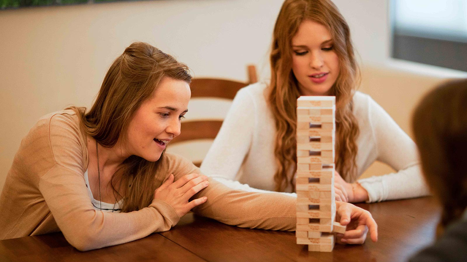 there are two women playing a game of jenga