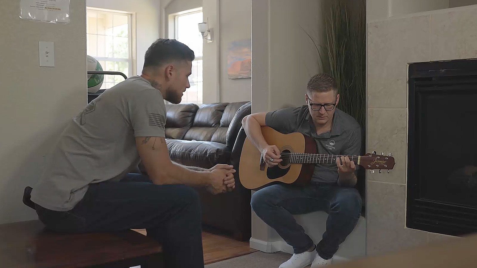 they are playing guitar in the living room of a home