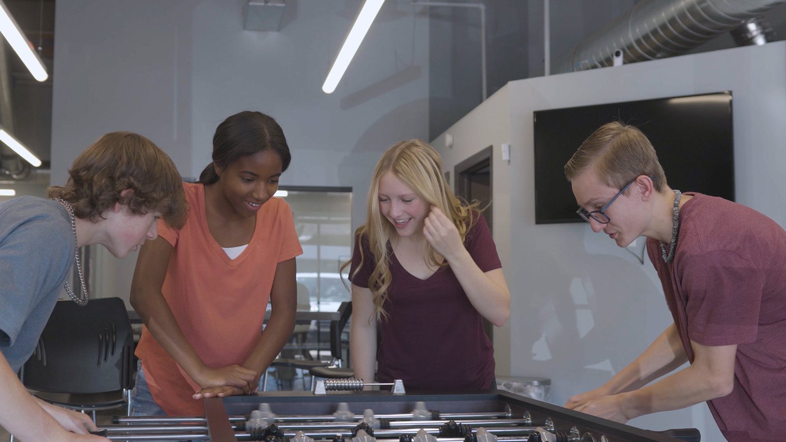 A group of teenage patients play foosball a the Mental Health Colorado Springs center.
