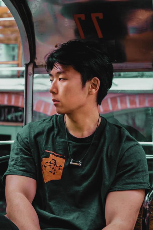 arafed man sitting on a bus looking out the window