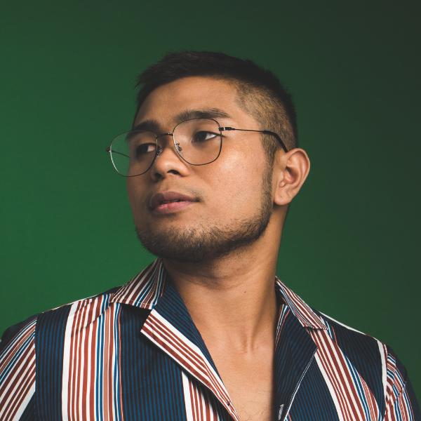 arafed man wearing glasses and a striped shirt looking up