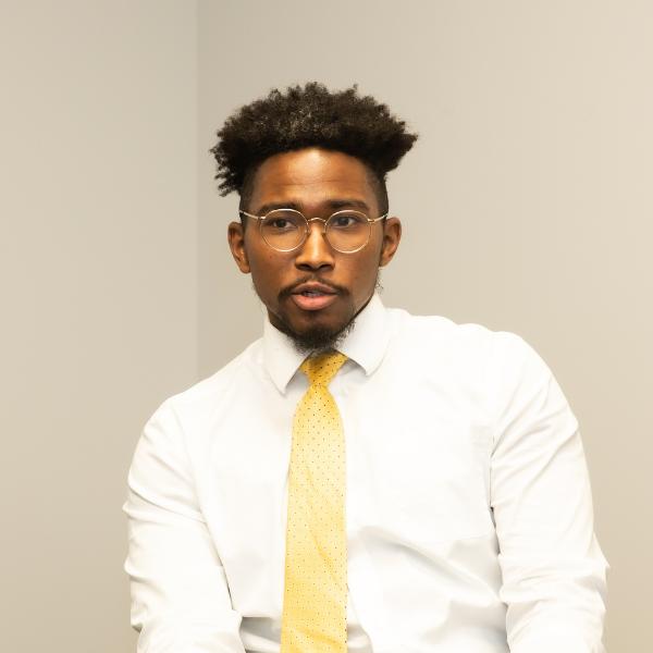 there is a man wearing a yellow tie and glasses