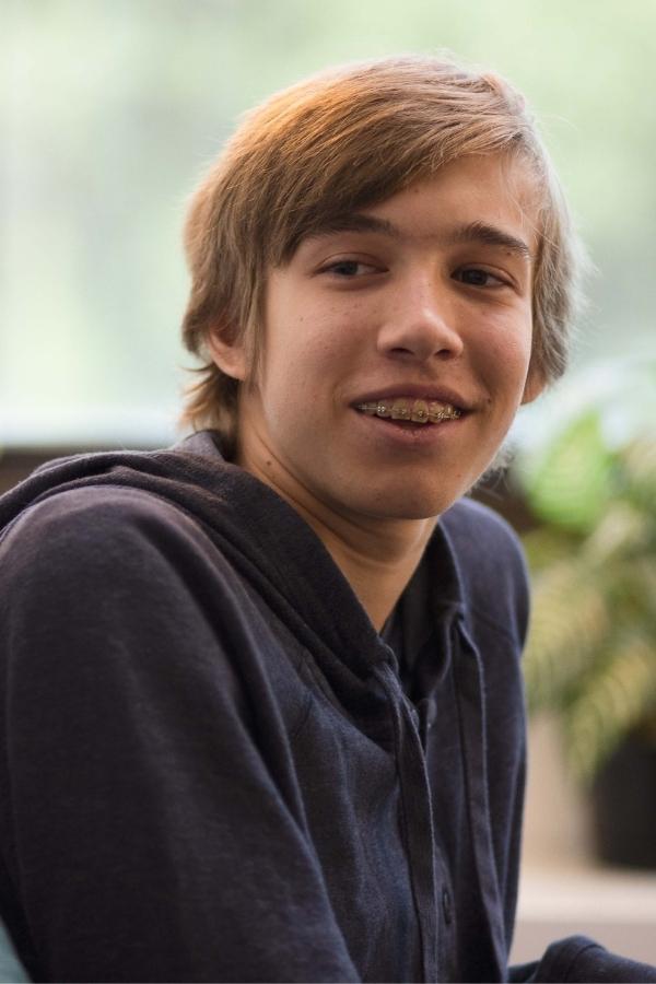arafed boy with a toothbrush in his mouth and a smile on his face