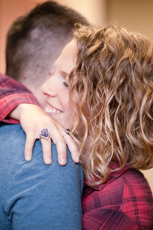 there is a man and woman hugging each other in a room