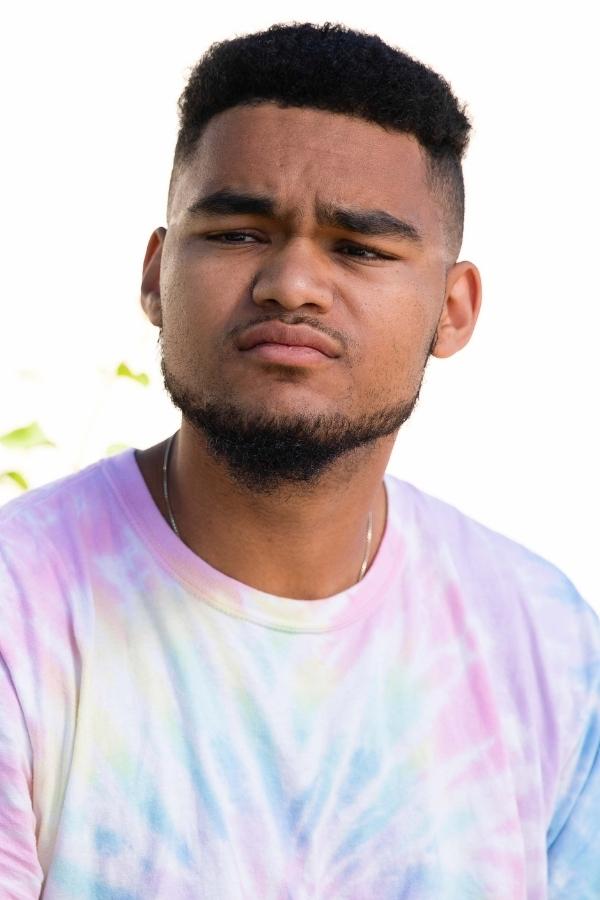 arafed man with a beard and a tie dye shirt