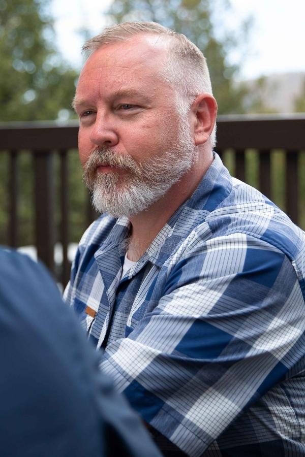 there is a man with a beard sitting on a bench