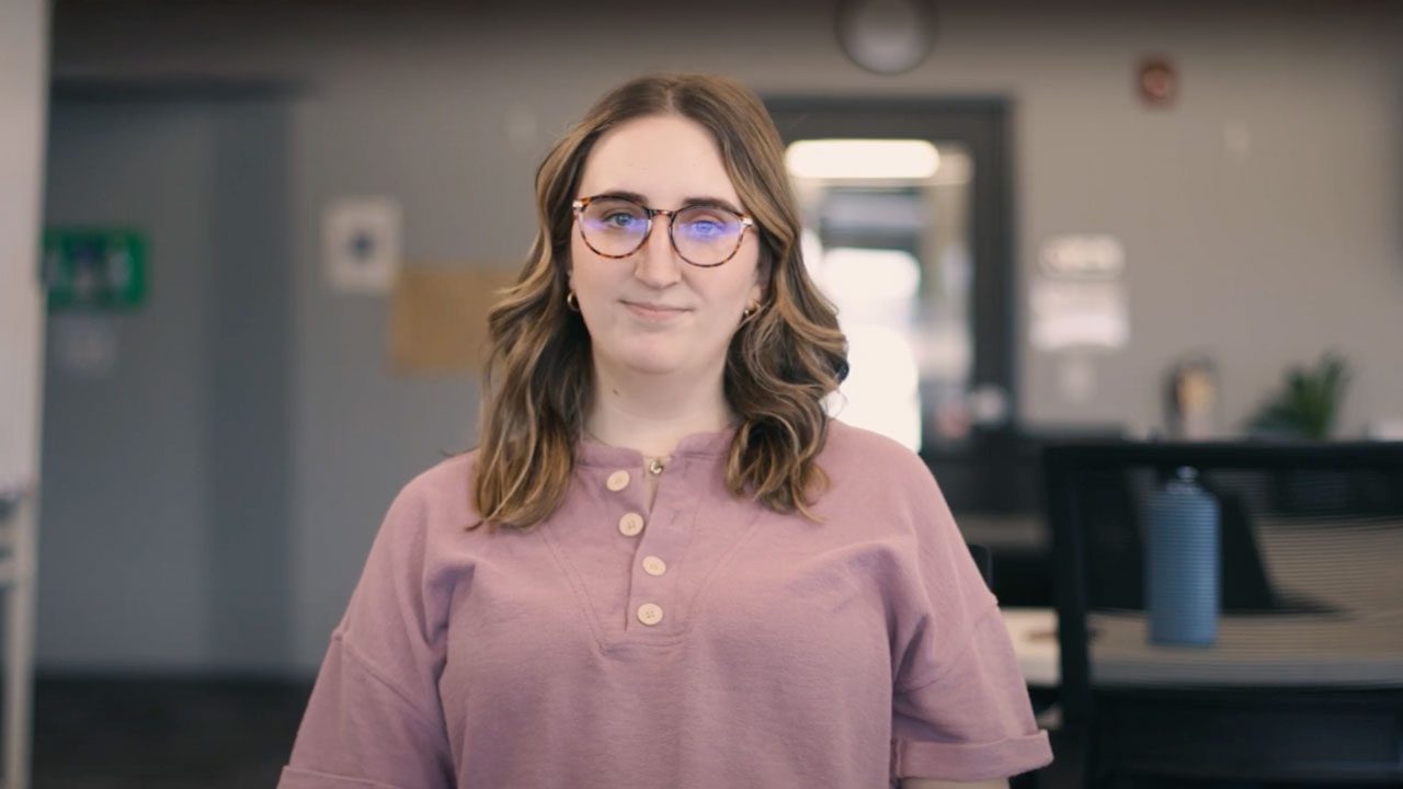there is a woman with glasses standing in an office