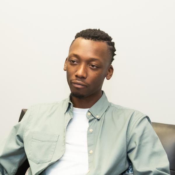 there is a man sitting in a chair with a remote control