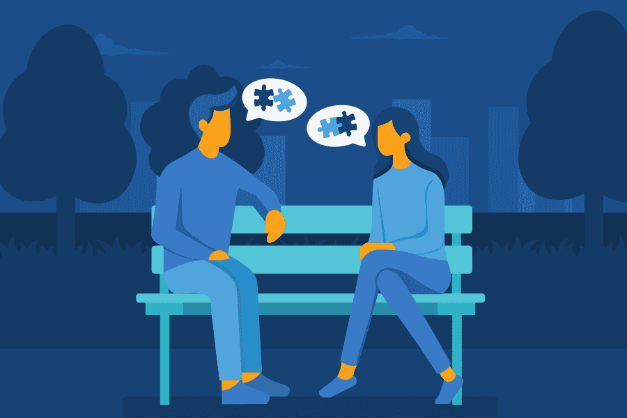 there are two people sitting on a bench talking to each other