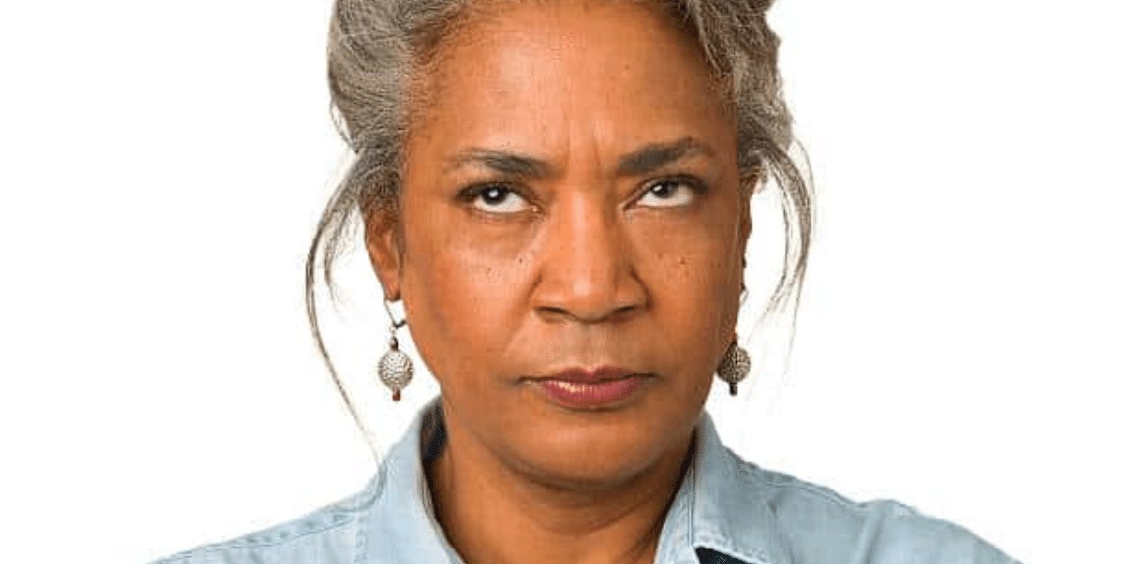 Portrait of a mature woman rolling eyes on a white background.