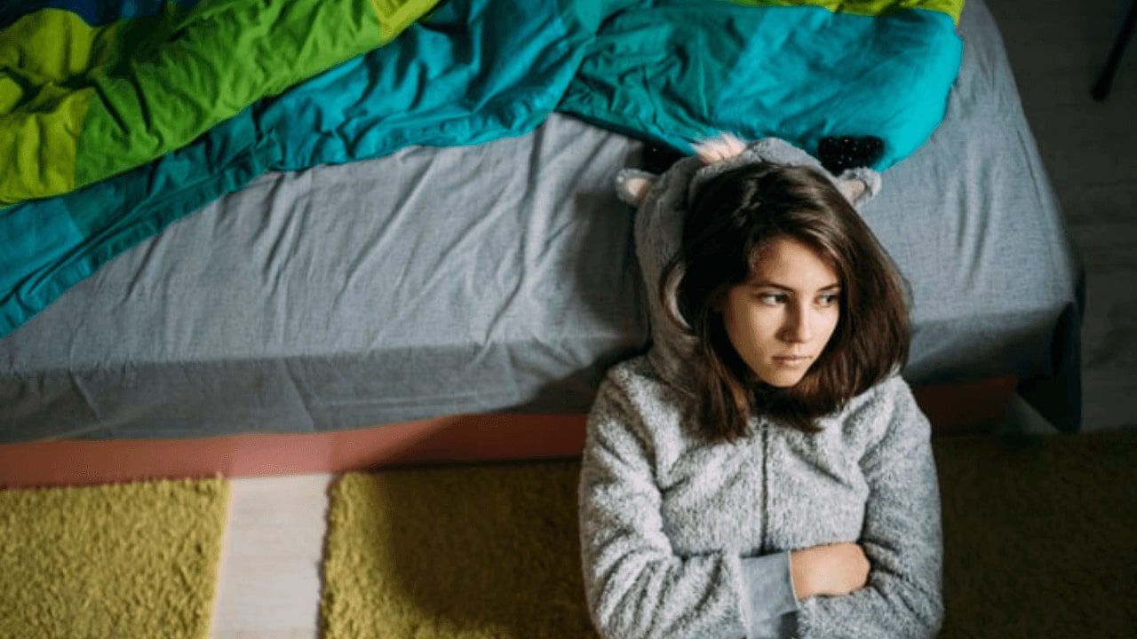arafed woman in a cat costume sitting on a bed