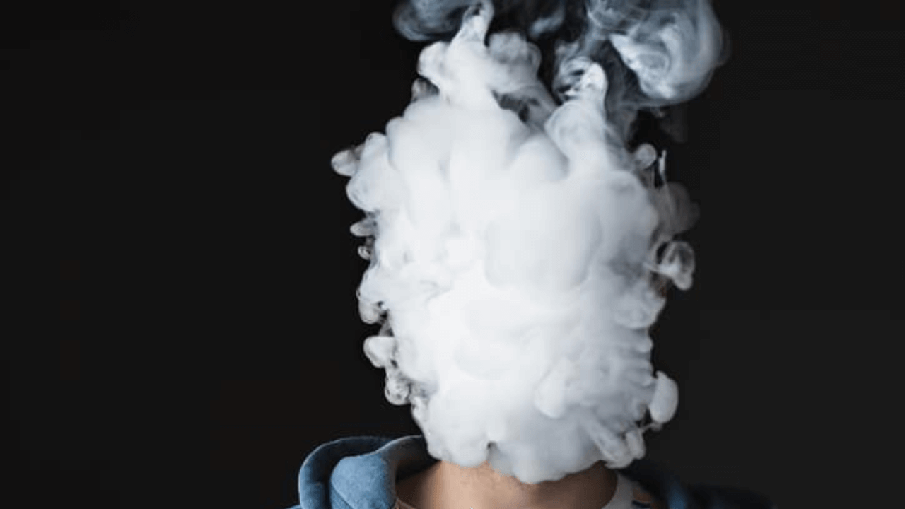 there is a man with a cloud of smoke on his head