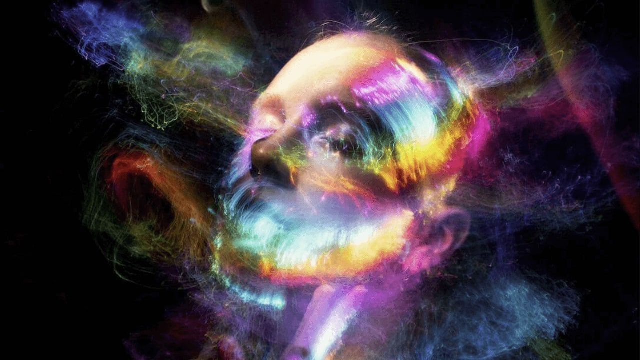 a close up of a person with a colorful face and a black background