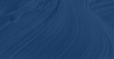 a close up of a blue wall with a white clock on it