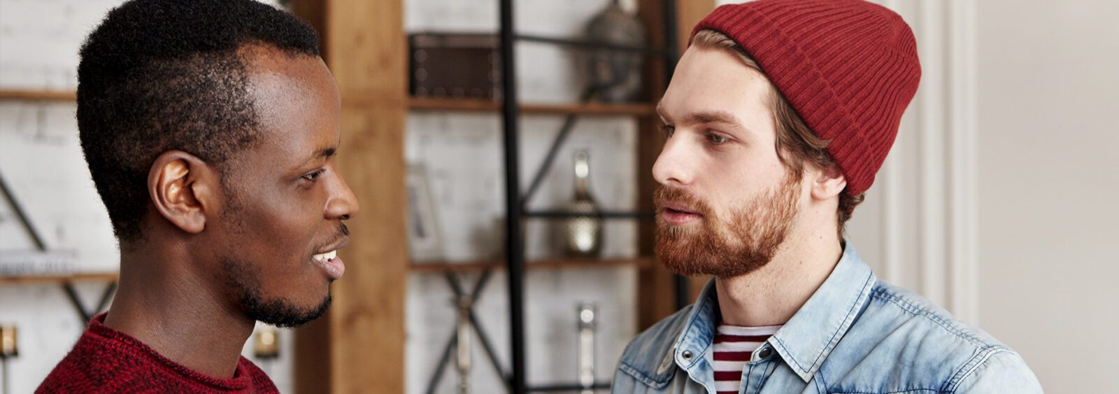 there are two men standing next to each other talking