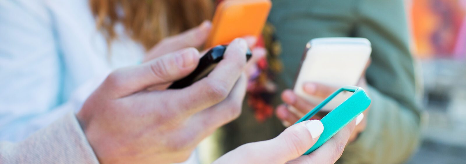 there are two people holding their cell phones in their hands