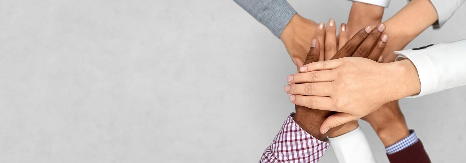several people are holding hands together in a circle