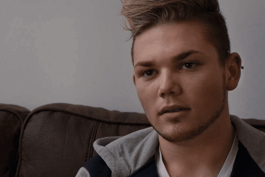 there is a man with a mohawk sitting on a couch