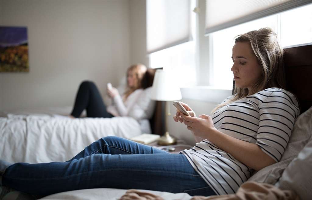 Adult women hanging out on their beds in Reston Sober Living