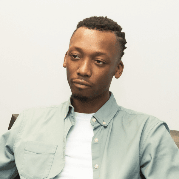 there is a man sitting in a chair with a tie on