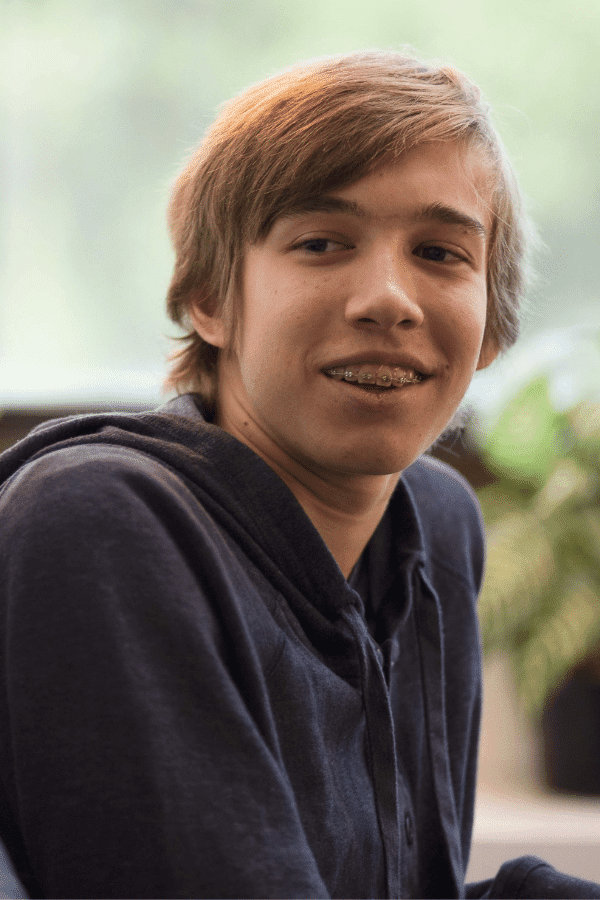 arafed boy with a toothbrush in his mouth and a smile on his face