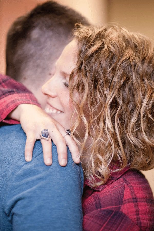 there is a man and woman hugging each other in a room