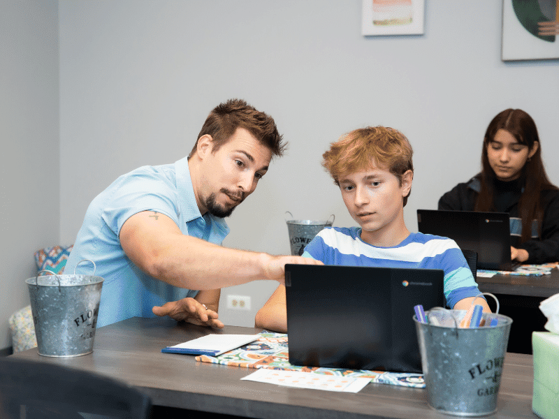 Academic advisor supporting teen with his academics