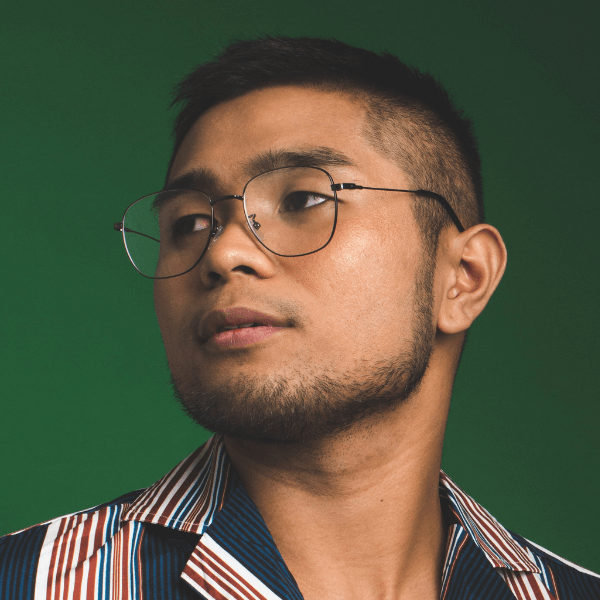 arafed man wearing glasses and a striped shirt looking up