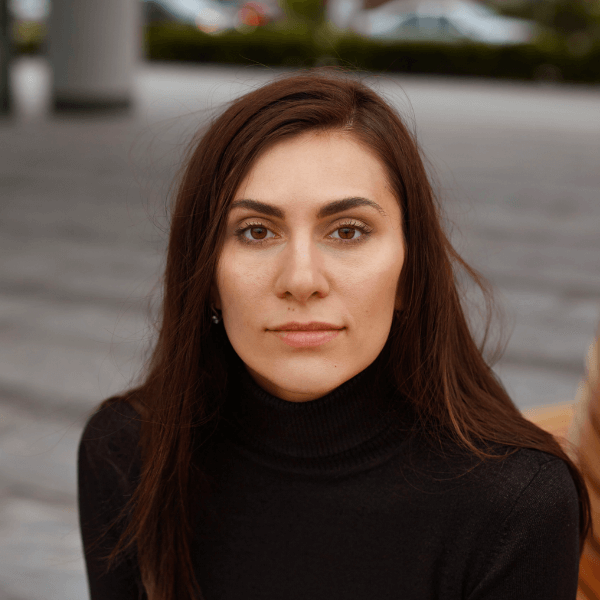 there is a woman that is sitting down with a cell phone