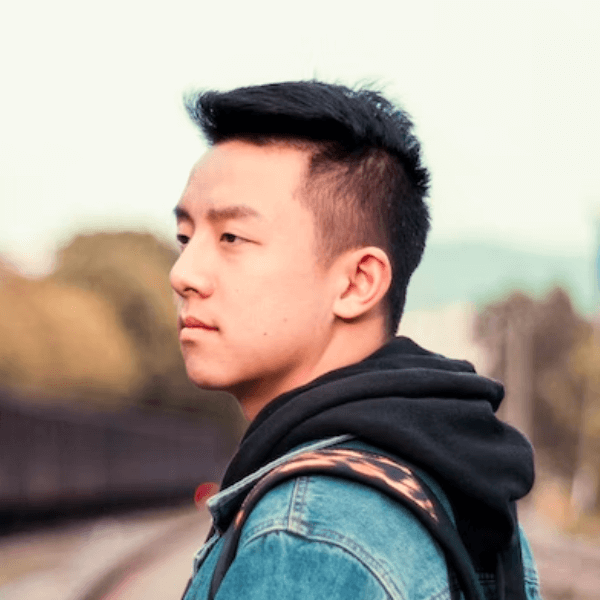 there is a man with a backpack standing on a train track