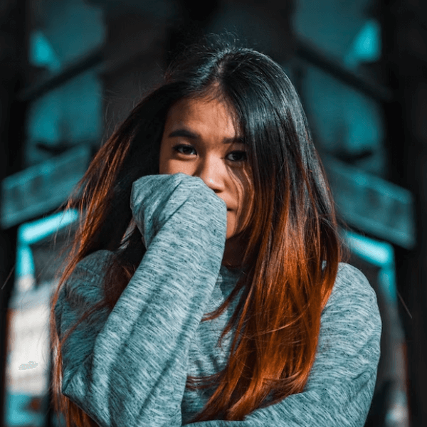 arafed woman with long hair covering her face with her hands