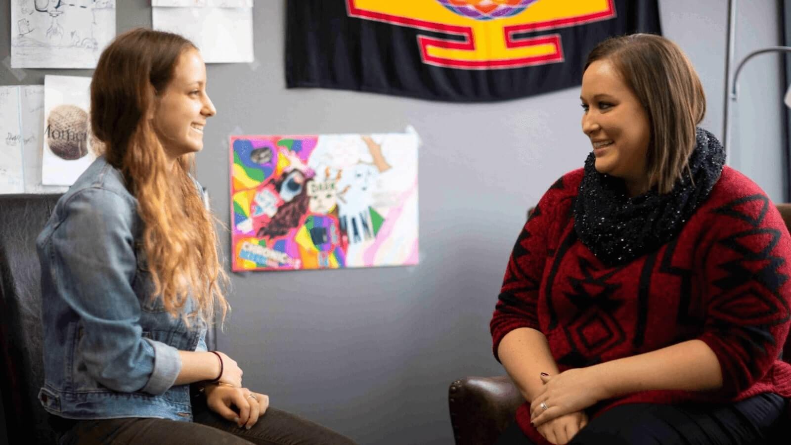 clinician speaking with client in therapy session