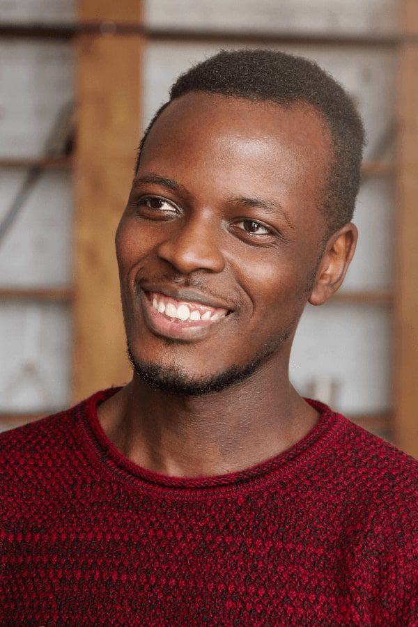 smiling man in red sweater with a red tie and a red sweater