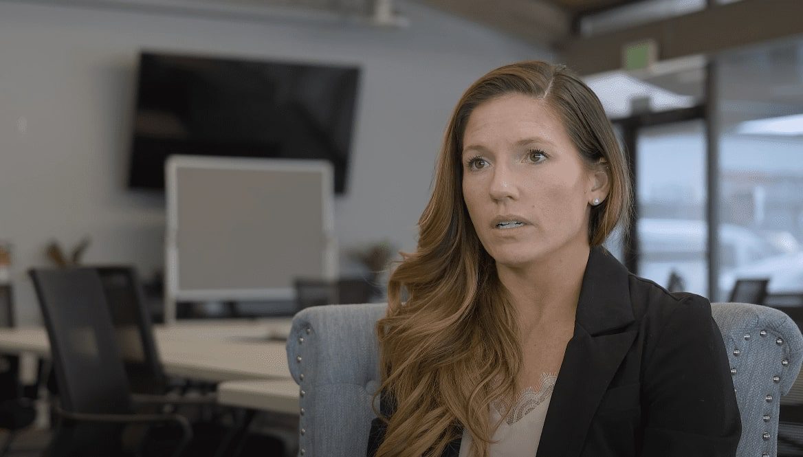 there is a woman sitting in a chair in an office