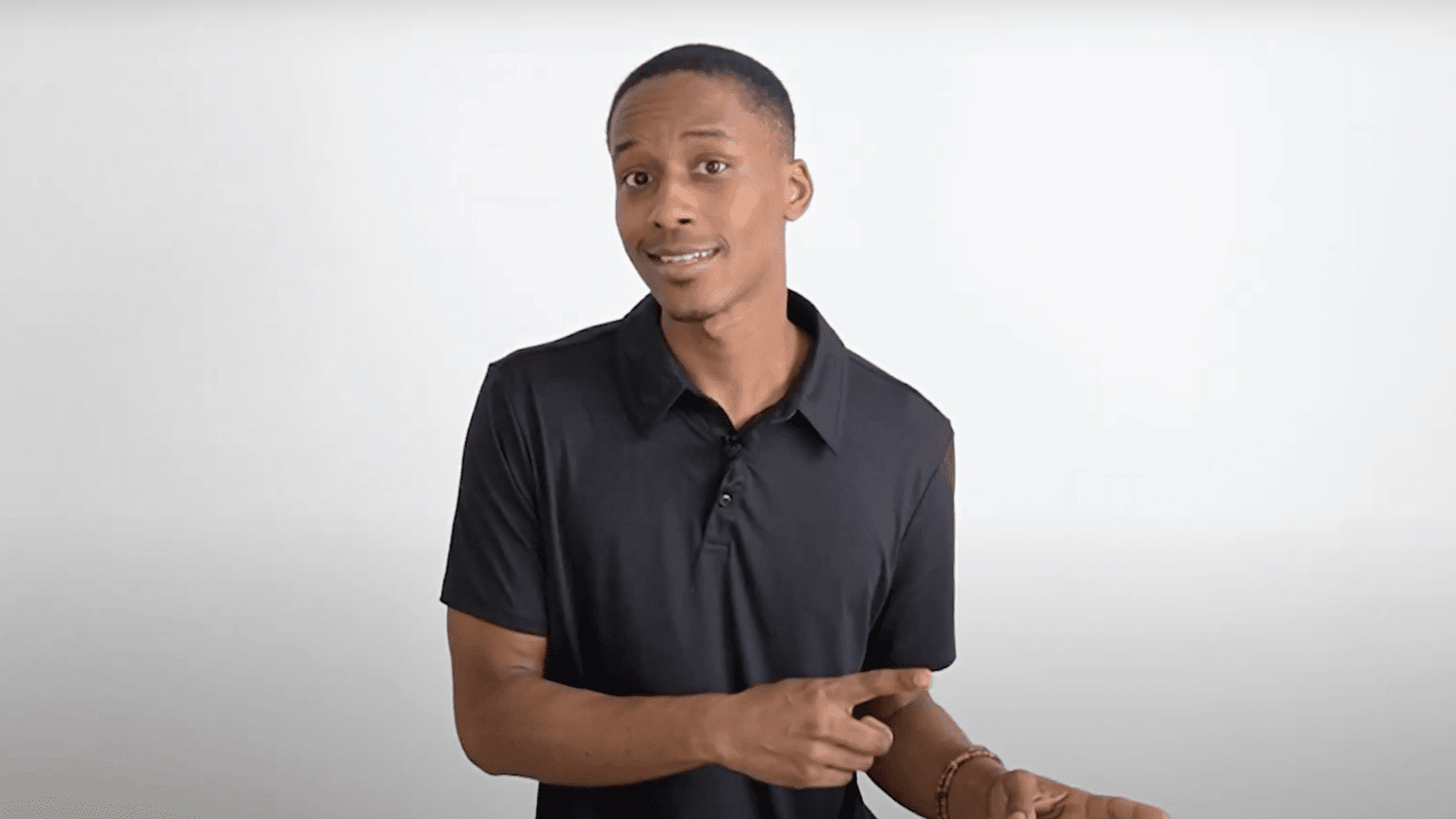 arafed man in a black shirt holding a knife and a knife