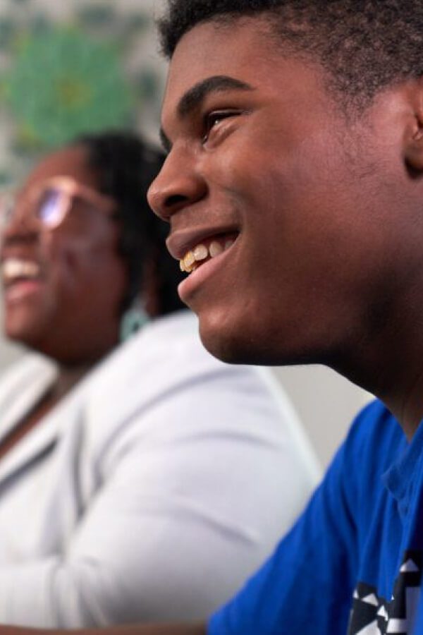 there are two people sitting at a table with a remote