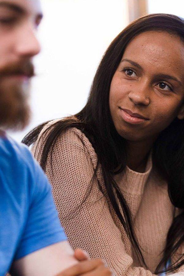 there is a woman sitting at a table with a man