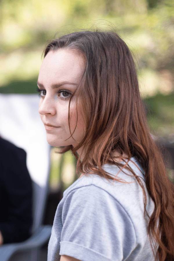 there is a woman sitting in a chair with a cell phone