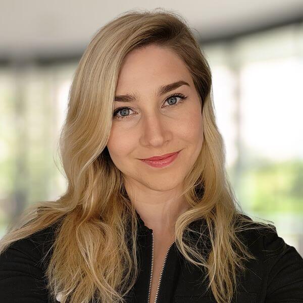 blond woman with long hair and blue eyes posing for a picture