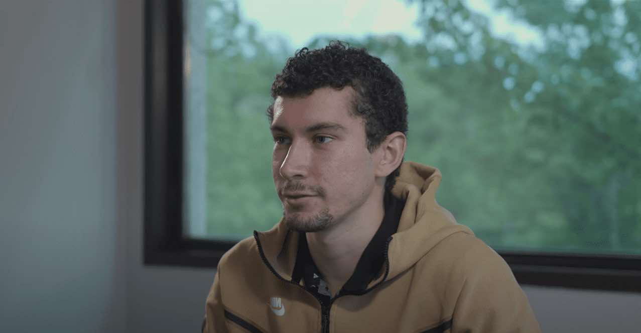 there is a man that is sitting in front of a window