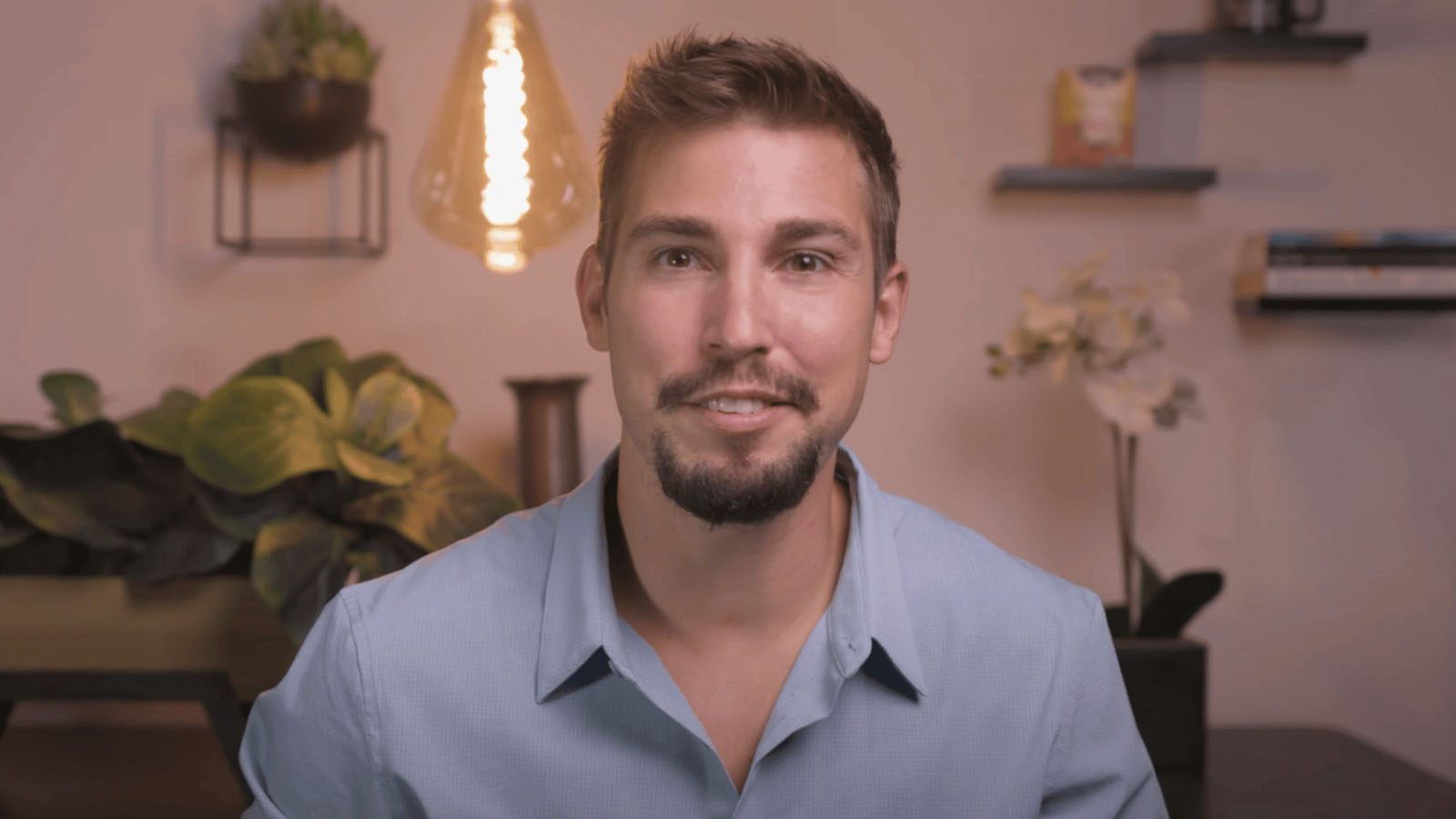 there is a man that is sitting down with a smile on his face