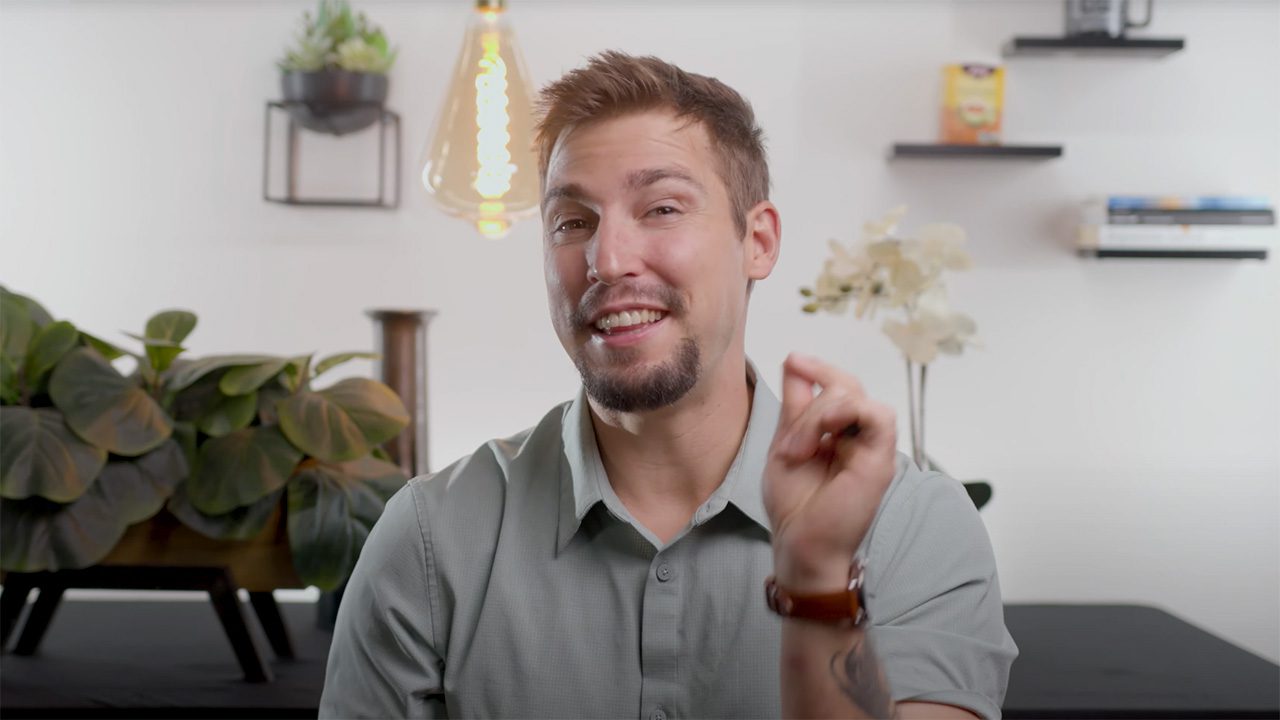 there is a man that is smiling and holding a cell phone