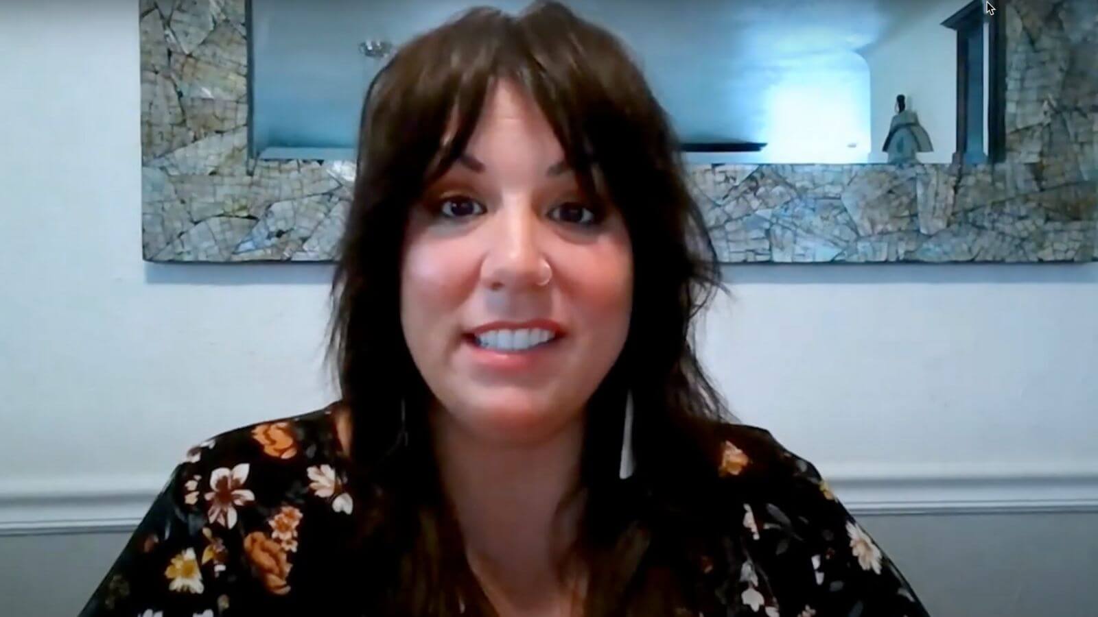 there is a woman that is smiling and looking at the camera