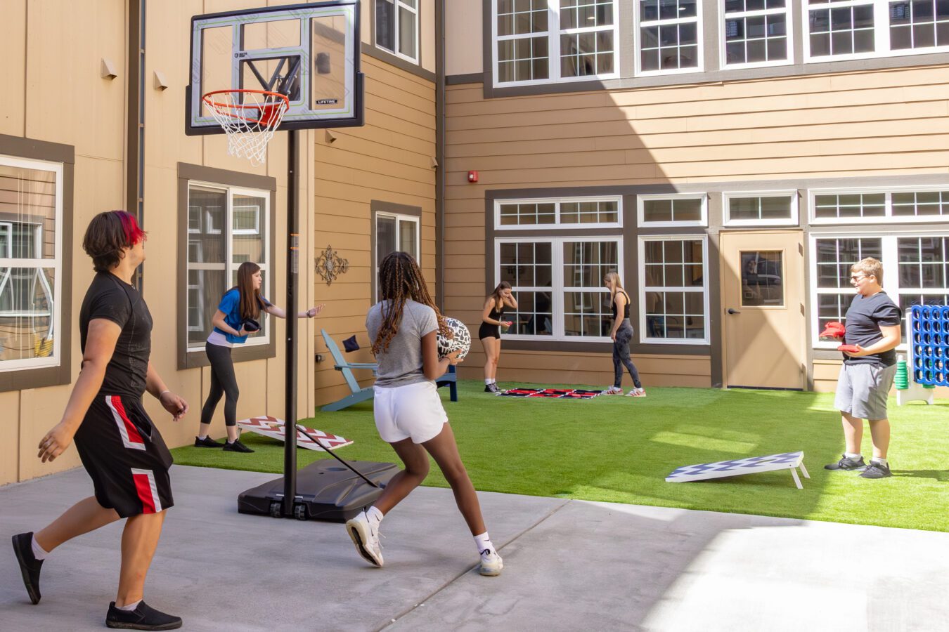 Teenage boys and girls playing basketball